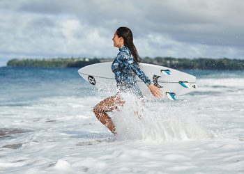 INTERVIEW: Pro Surfer Malia Manuel On Her Swimwear Collaboration With lululemon, Summer Essentials, Favorite Spot To Surf, And More