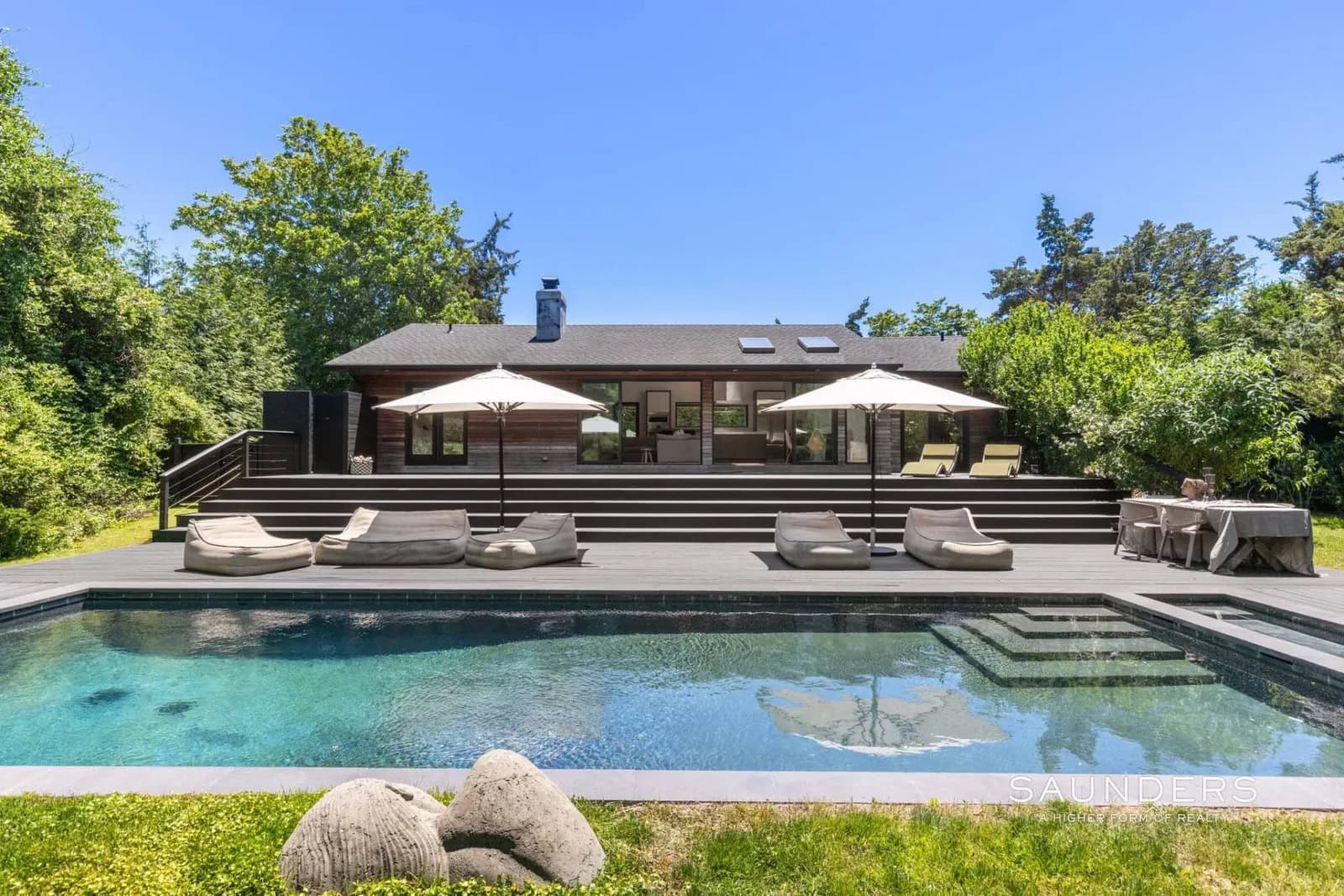 Discover a private Hamptons sanctuary where modern luxury meets coastal serenity. Hidden behind electronic gates and surrounded by lush, thoughtfully curated gardens, this fully renovated retreat offers a rare sense of peace just moments from the heart of Sag Harbor Village.