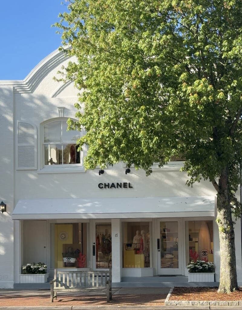 Where coastal elegance meets high fashion. East Hampton continues to attract some of the world's most coveted brands, transforming its charming streets into a summer destination for luxury shopping. From Chanel, Prada, and Louis Vuitton to Brunello Cucinelli, Loro Piana, Loewe, and Ralph Lauren, Main Street and Newtown Lane are lined with iconic fashion houses that blend coastal charm with world-class style.