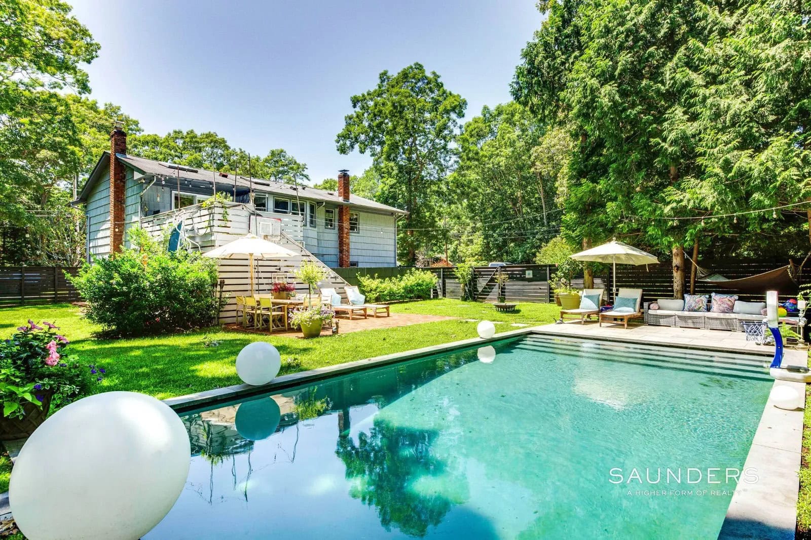 Nestled on a beautifully landscaped 0.46-acre corner lot in the heart of Springs, this impeccably maintained 2,030 square ft. 4-bedroom, 3-bathroom home offers the perfect blend of modern comfort, flexible living, and exceptional indoor-outdoor entertaining. Fully renovated in 2018, the home's light-filled upper level features an open-concept kitchen, living, and dining area where glass doors lead to a spacious deck overlooking the private backyard-ideal for morning coffee or evening gatherings.